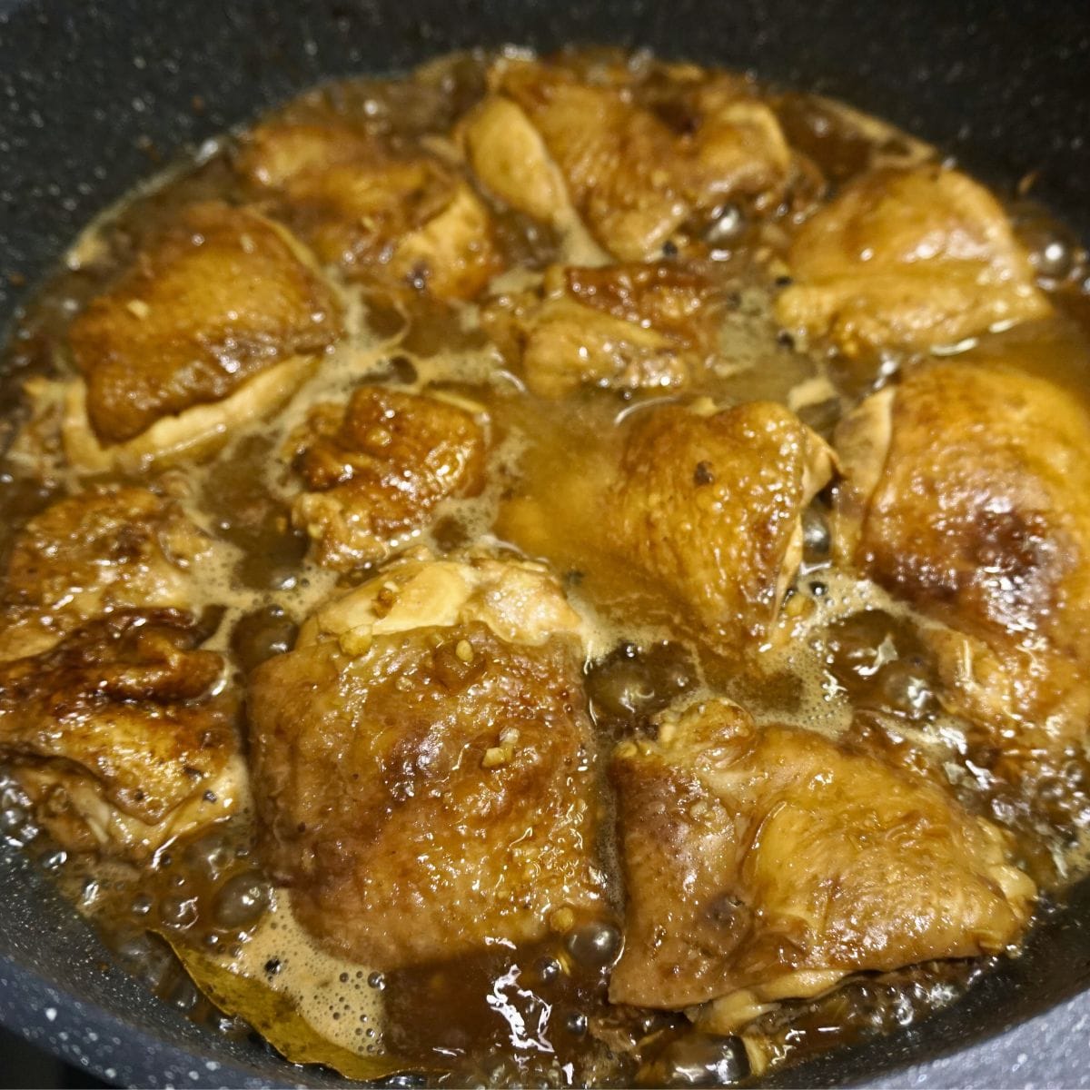 Chicken thighs cooked in a pot with soy sauce and vinegar.