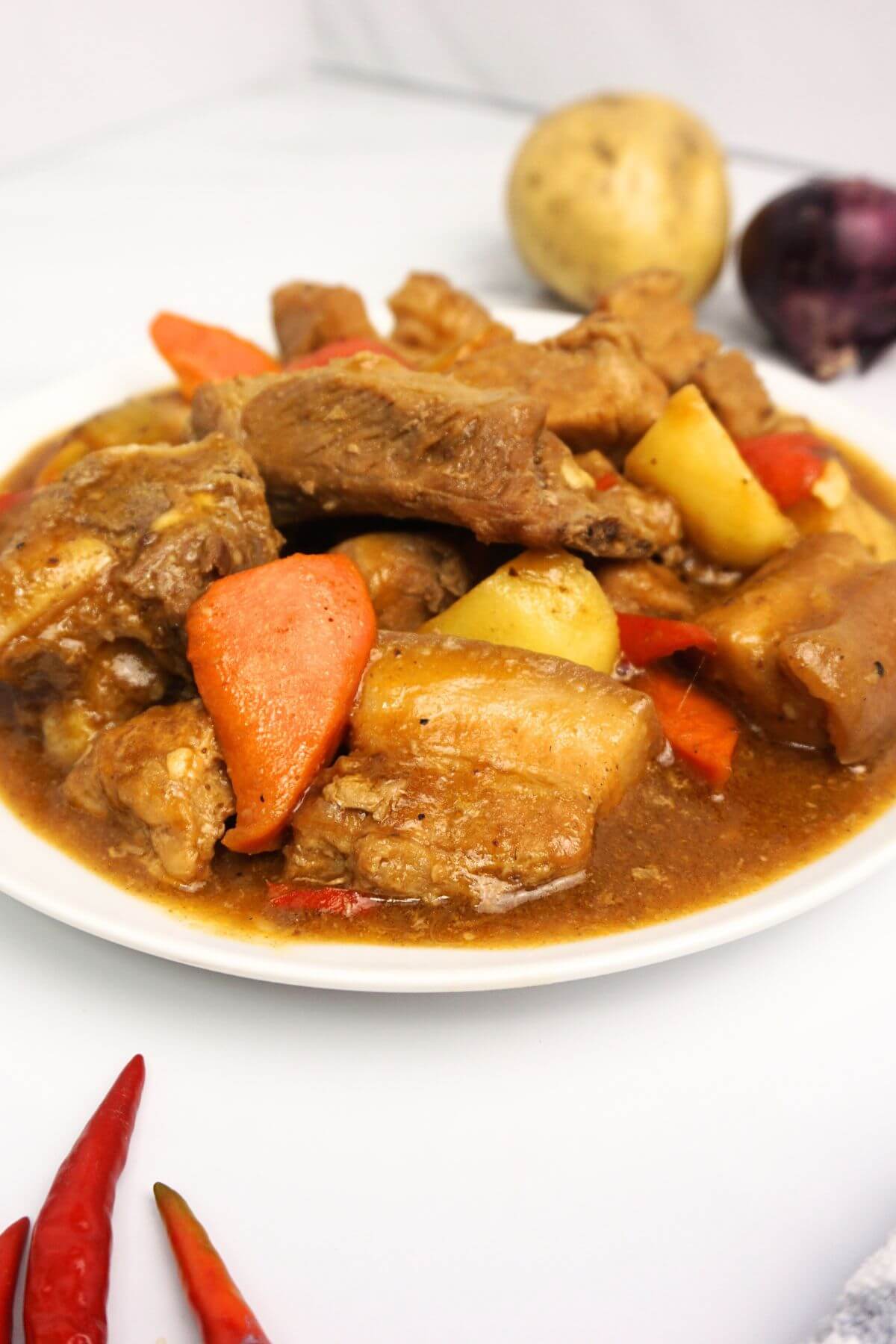Close-up view of a plate of pork caldereta.