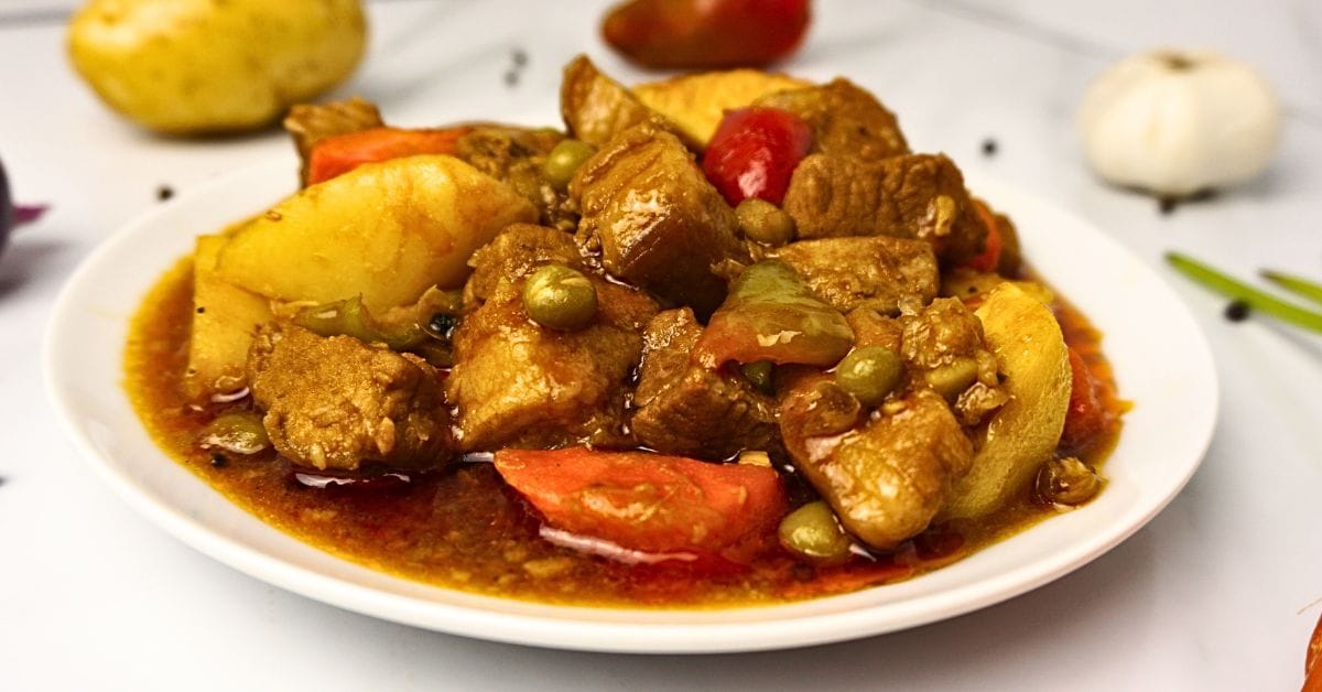 Pork mechado served in a white plate.