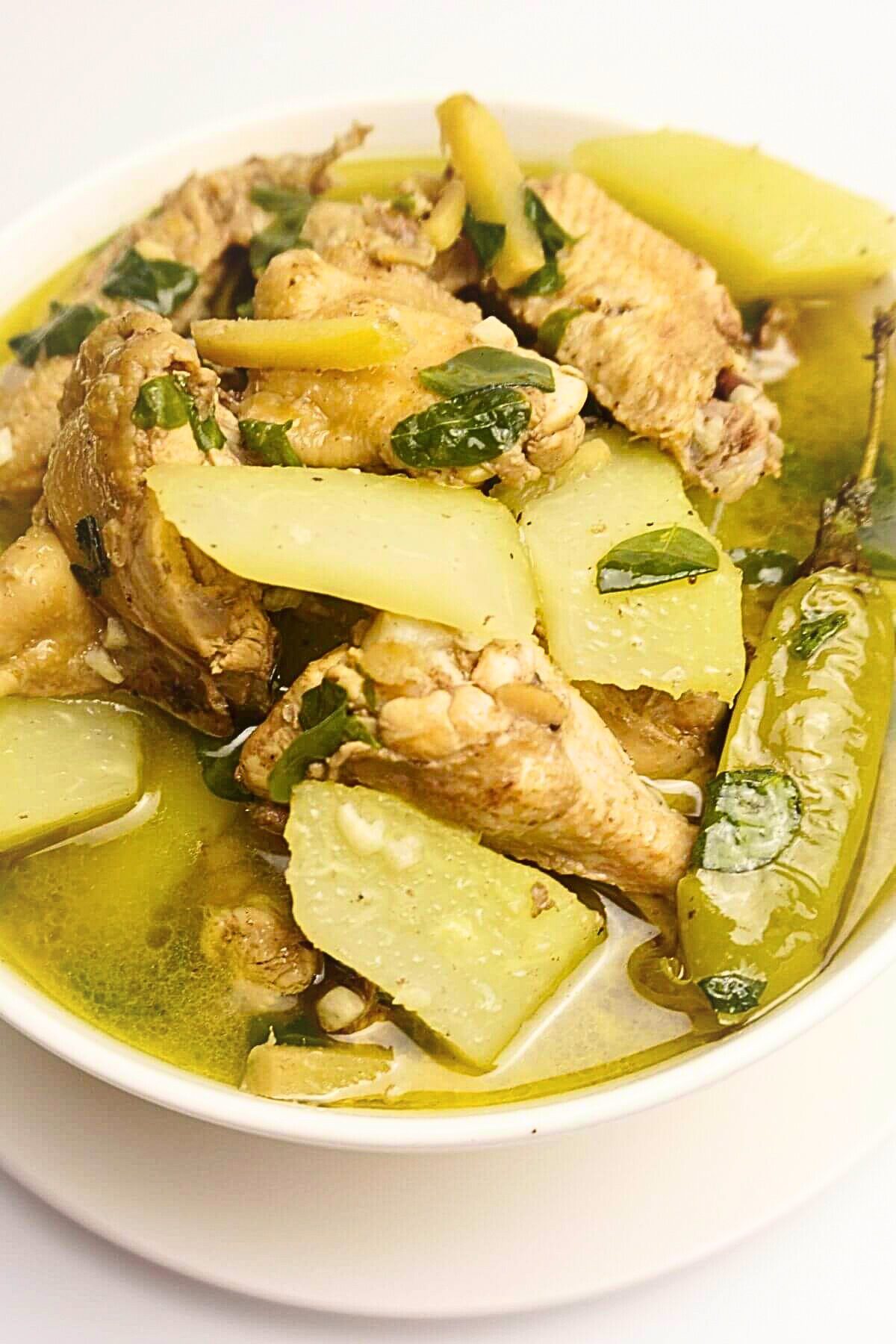 Chicken tinola in a white bowl.