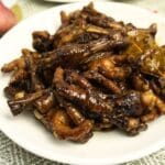 Adobong paa ng manok in a plate with spices on the table.