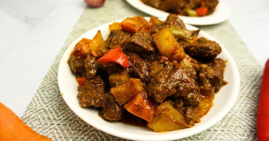 Beef mechado in plates.