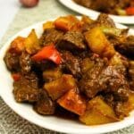 Beef mechado in plates.