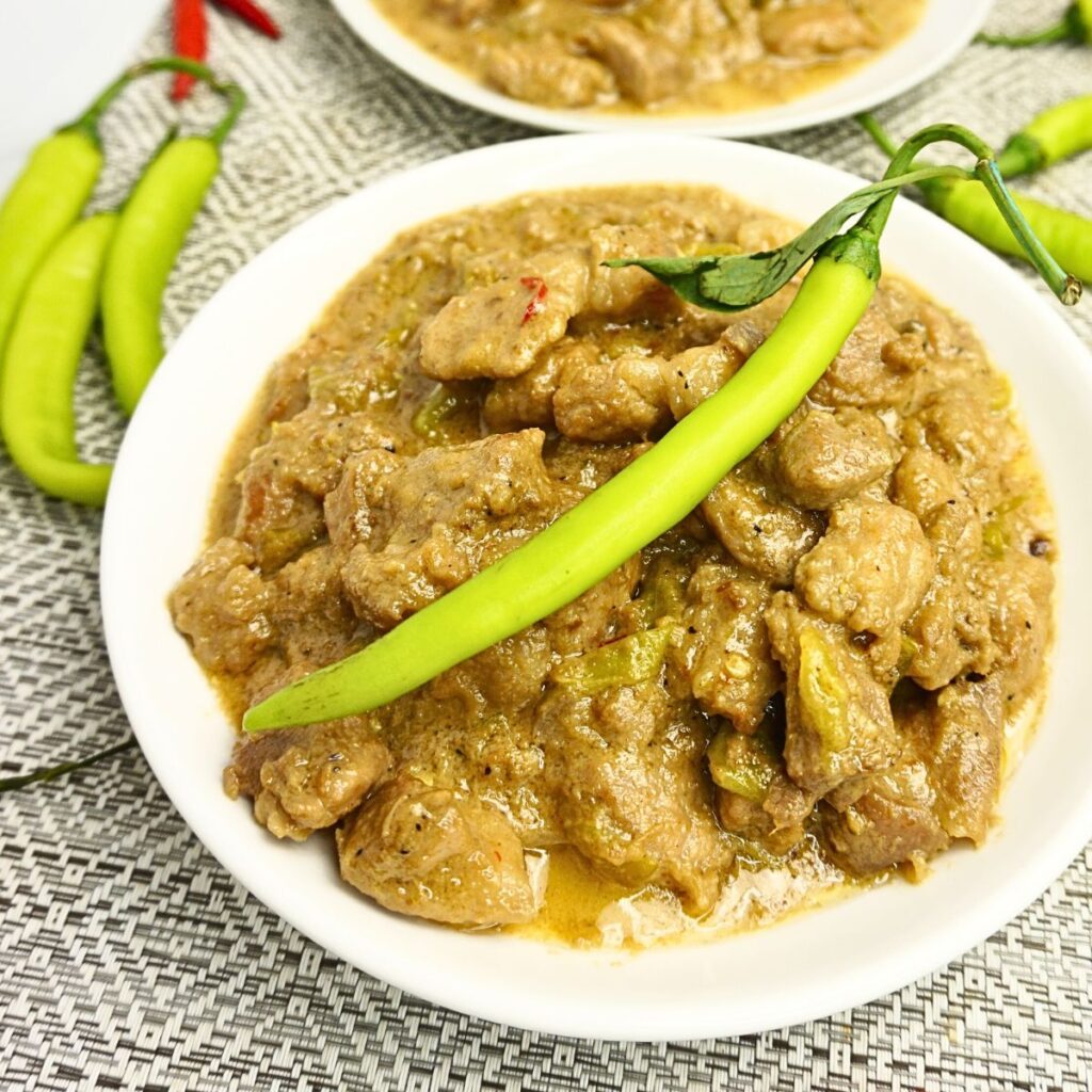 Creamy bicol express wth chile served in a white plate