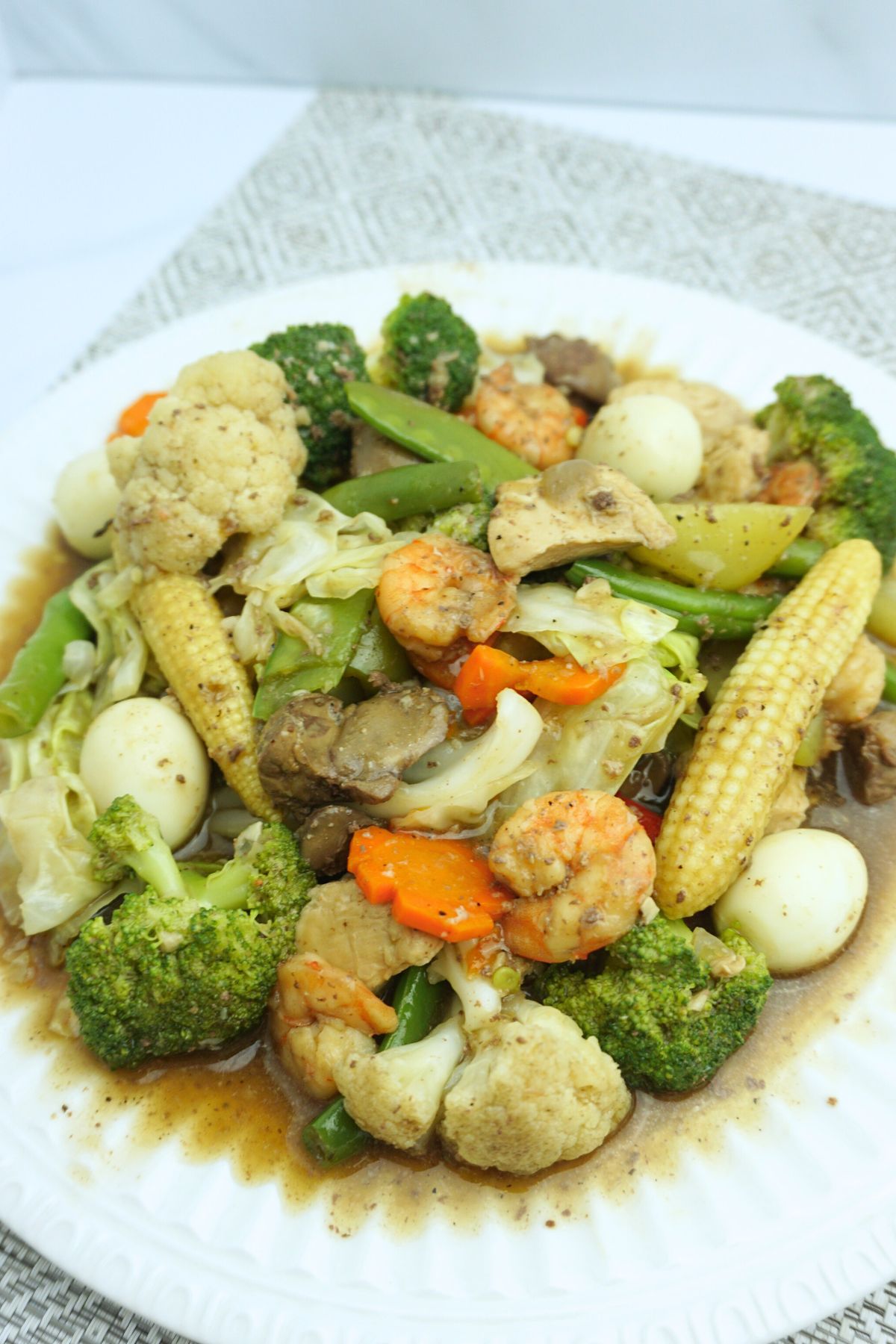 Colorful mix of vegetables chopseuy served in a white plate