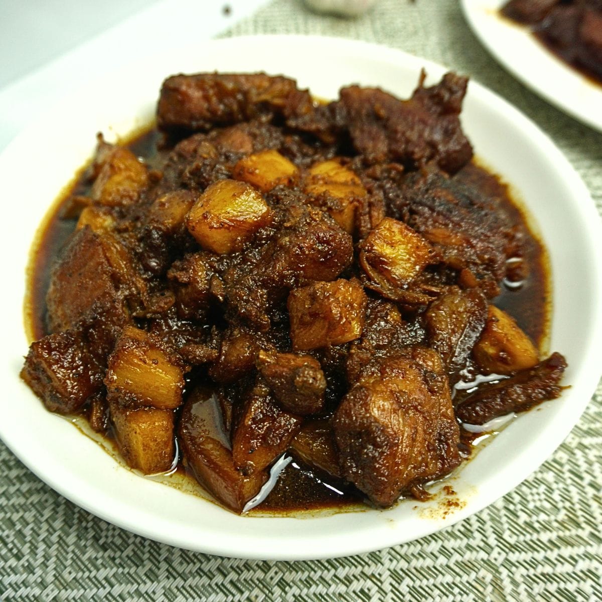 Pork sauteed in pineapple juice with fresh pineapple chunks.