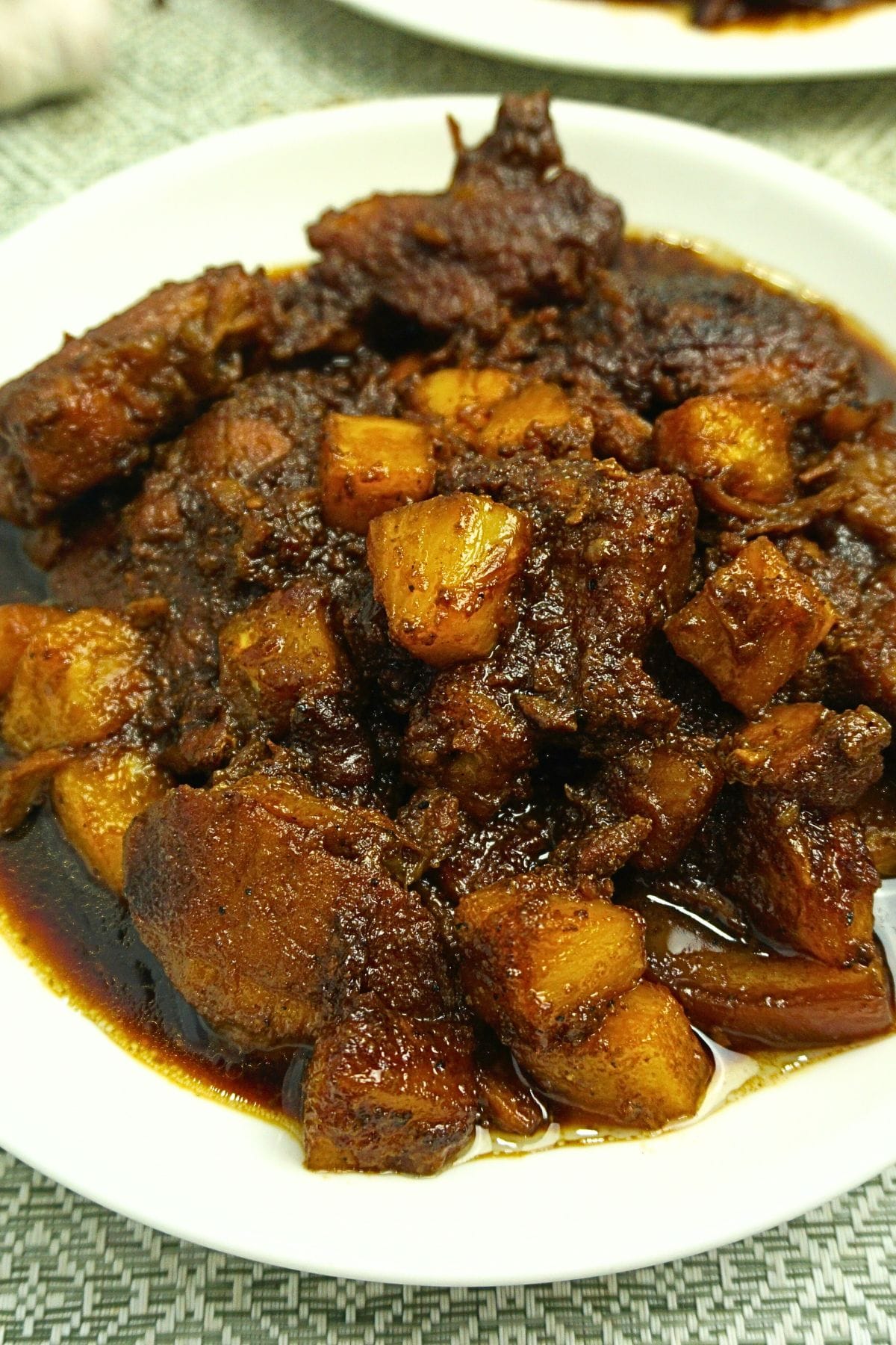 Pork cooked in pineapple juice with fresh pineapples.