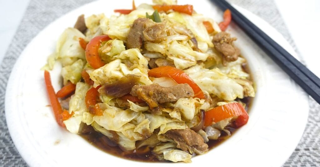 Ginisang repolyo in a plate with chopsticks.