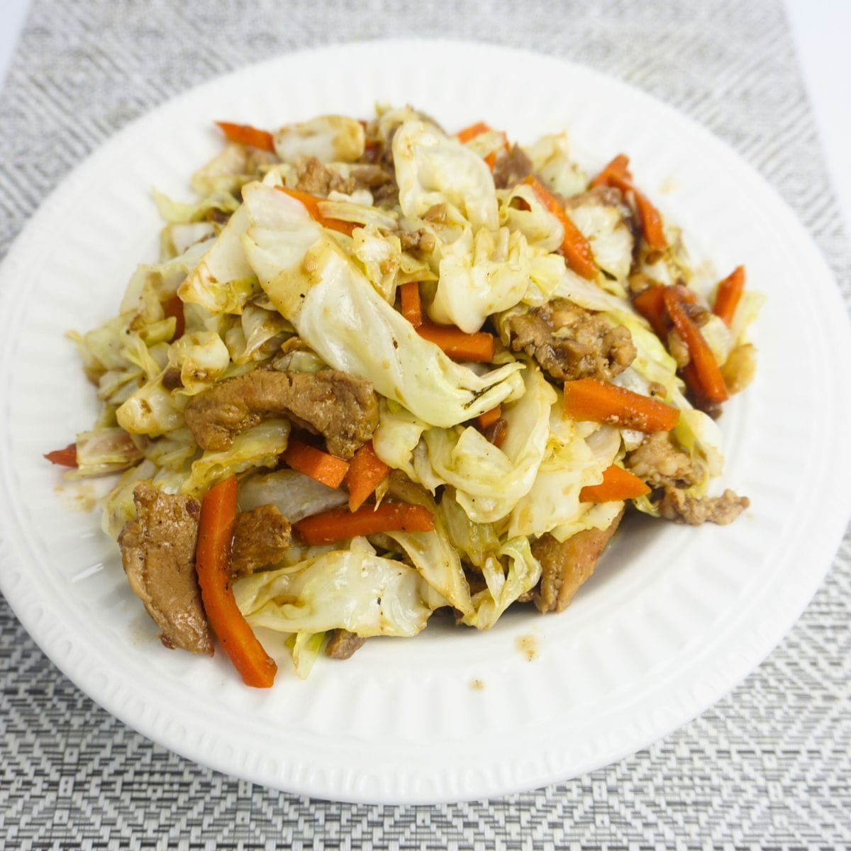 Sauteed cabbage and carrots with thin sliced of pork.