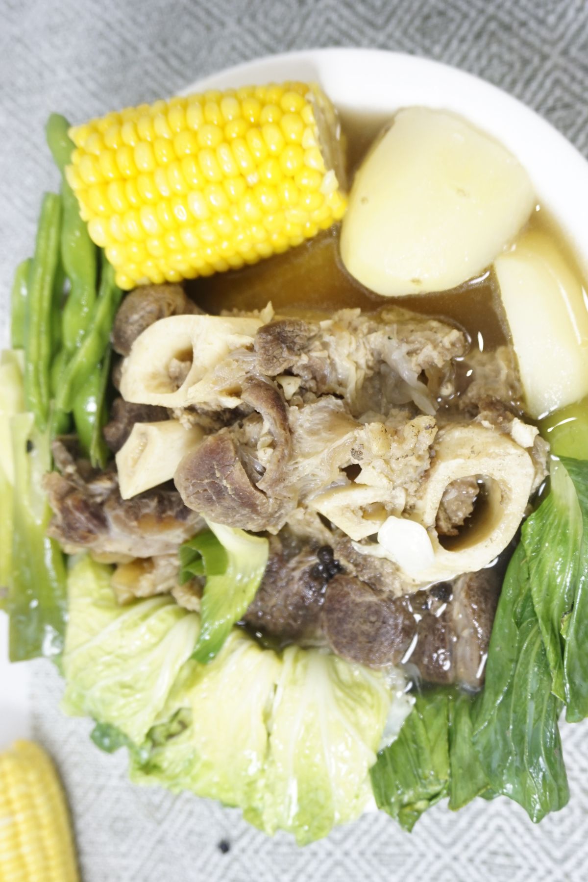 Beef bulalo in a large white bowl