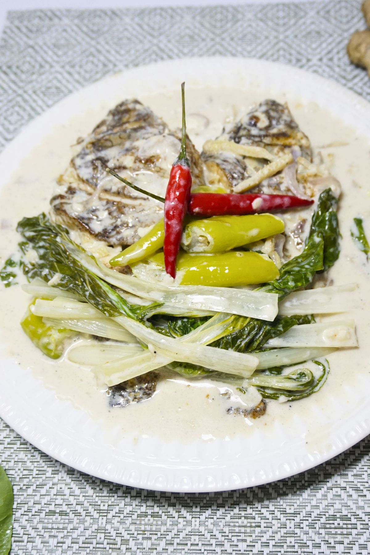 Fried tilapia with coconut cream sauce.