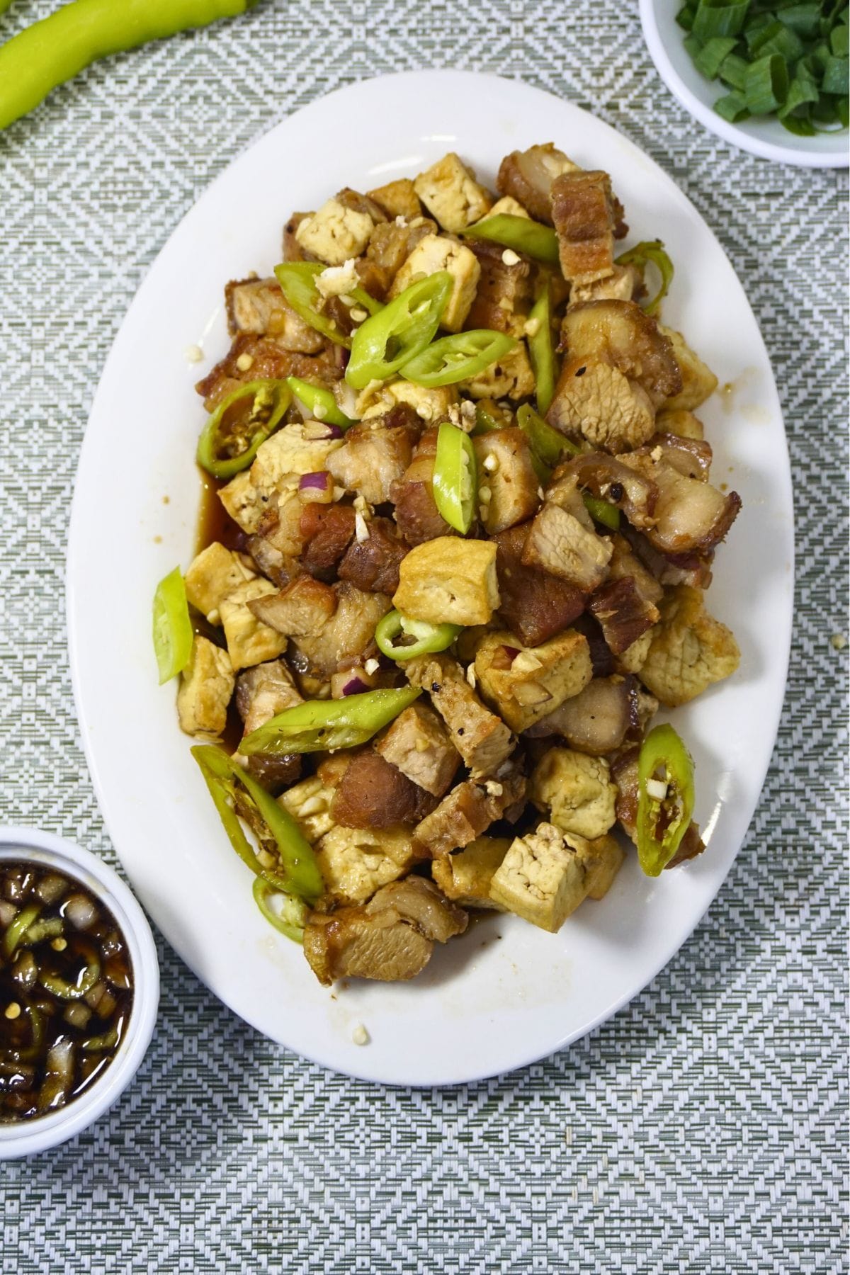 Tokwa't baboy on an oval plate with sauce on the side