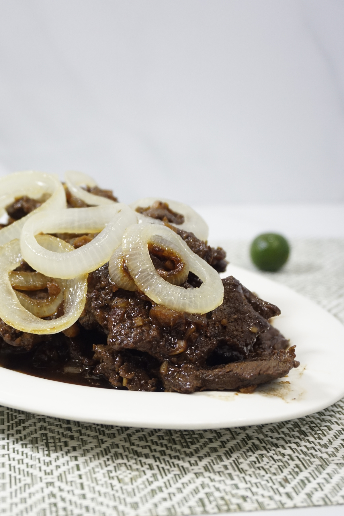Bistek tagalog served in an oval plate