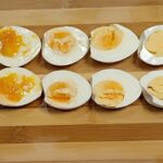 Boiled eggs in a wooden board.
