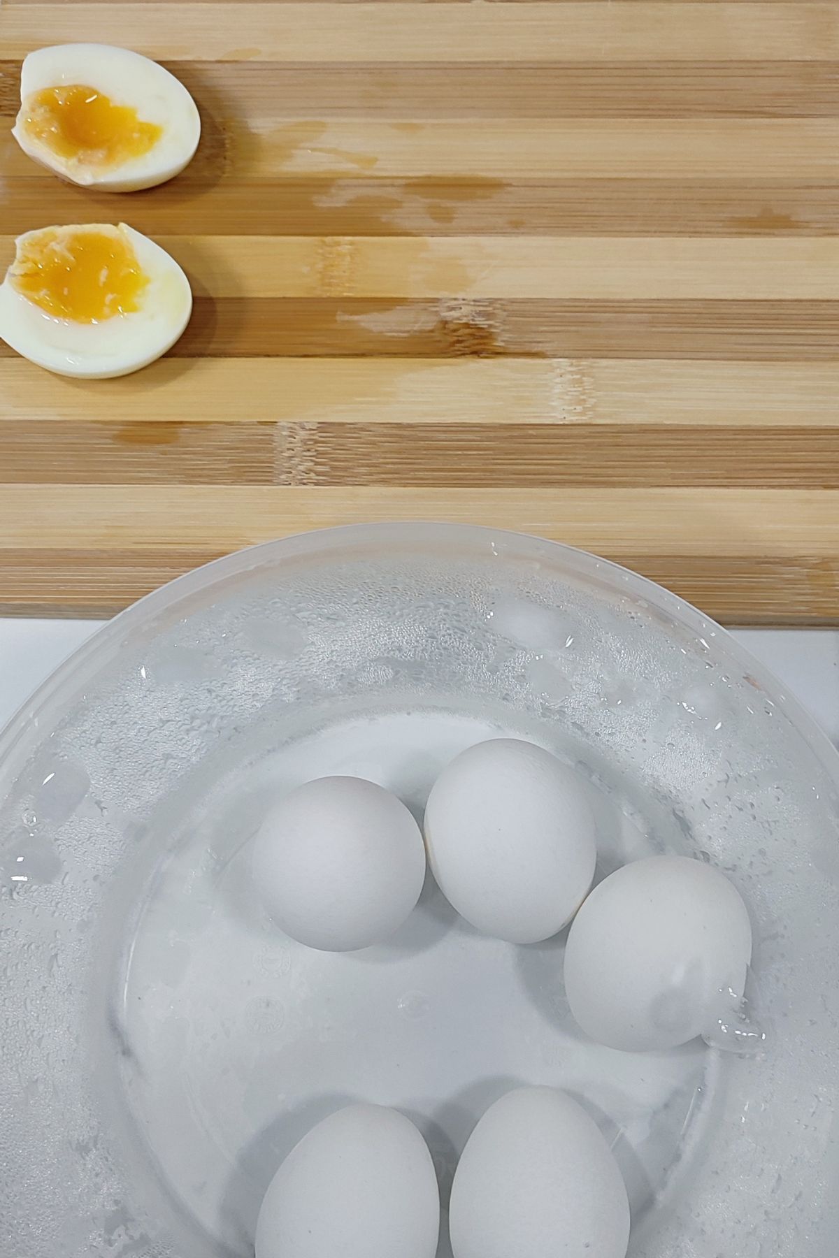 Boiled eggs in a bowl of ice bath.