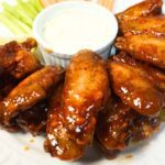 Buffalo wings in a plate with blue cheese dressing.