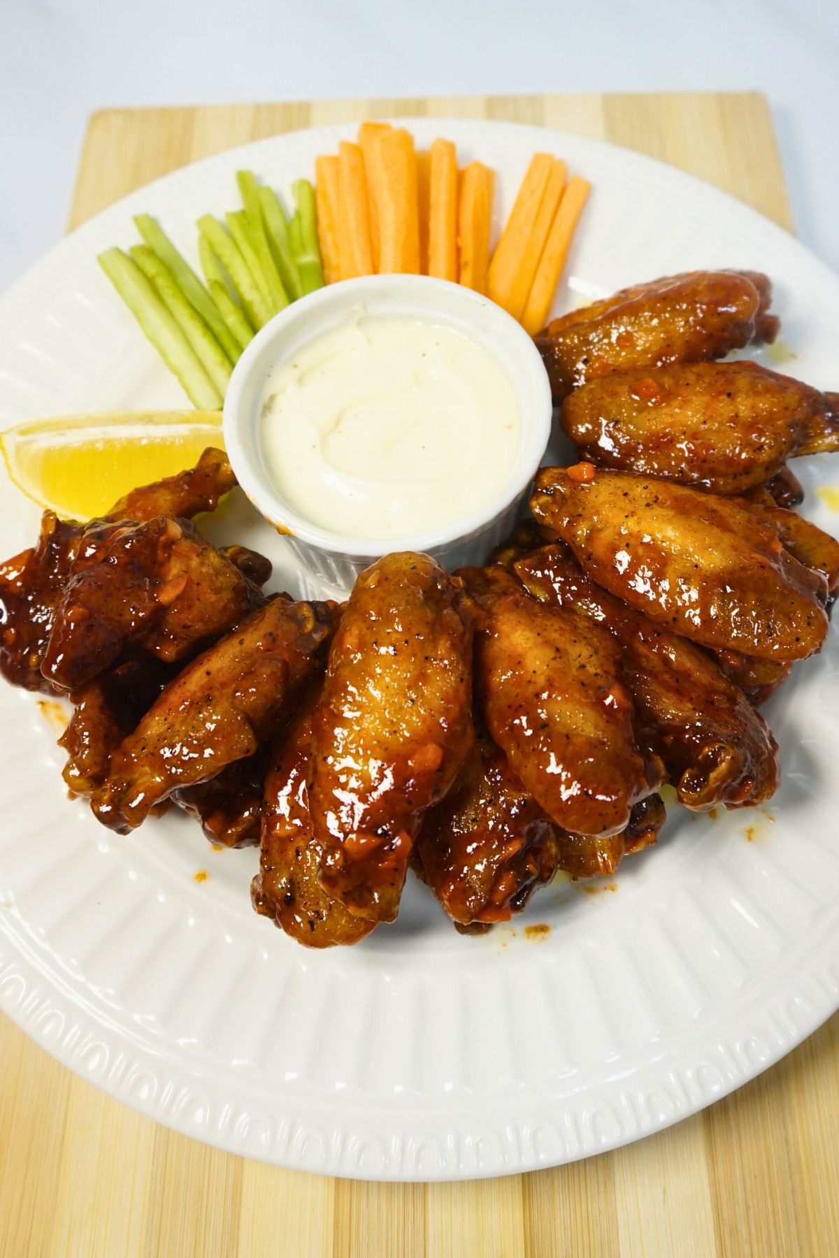 Fried wings coated in hot sauce and ketchup mixture.