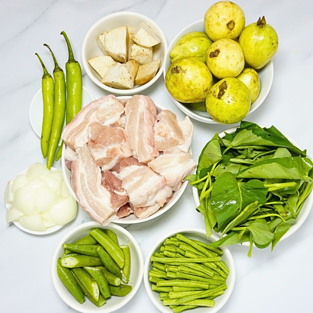 Pork bulanglang ingredients. Pork belly, guava, kangkong, snake beans, okra, onion, green chilies, and taro.