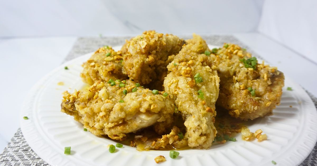 Garlic buttered chicken on plate.