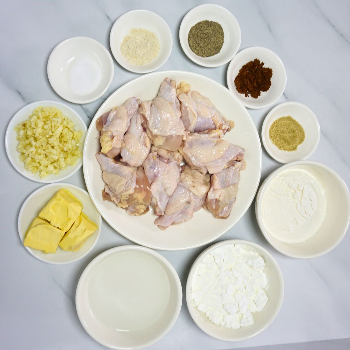 Garlic buttered chicken ingredients. Chicken slices, butter, garlic, salt, pepper, water, chicken powder, flour and cornstarch.