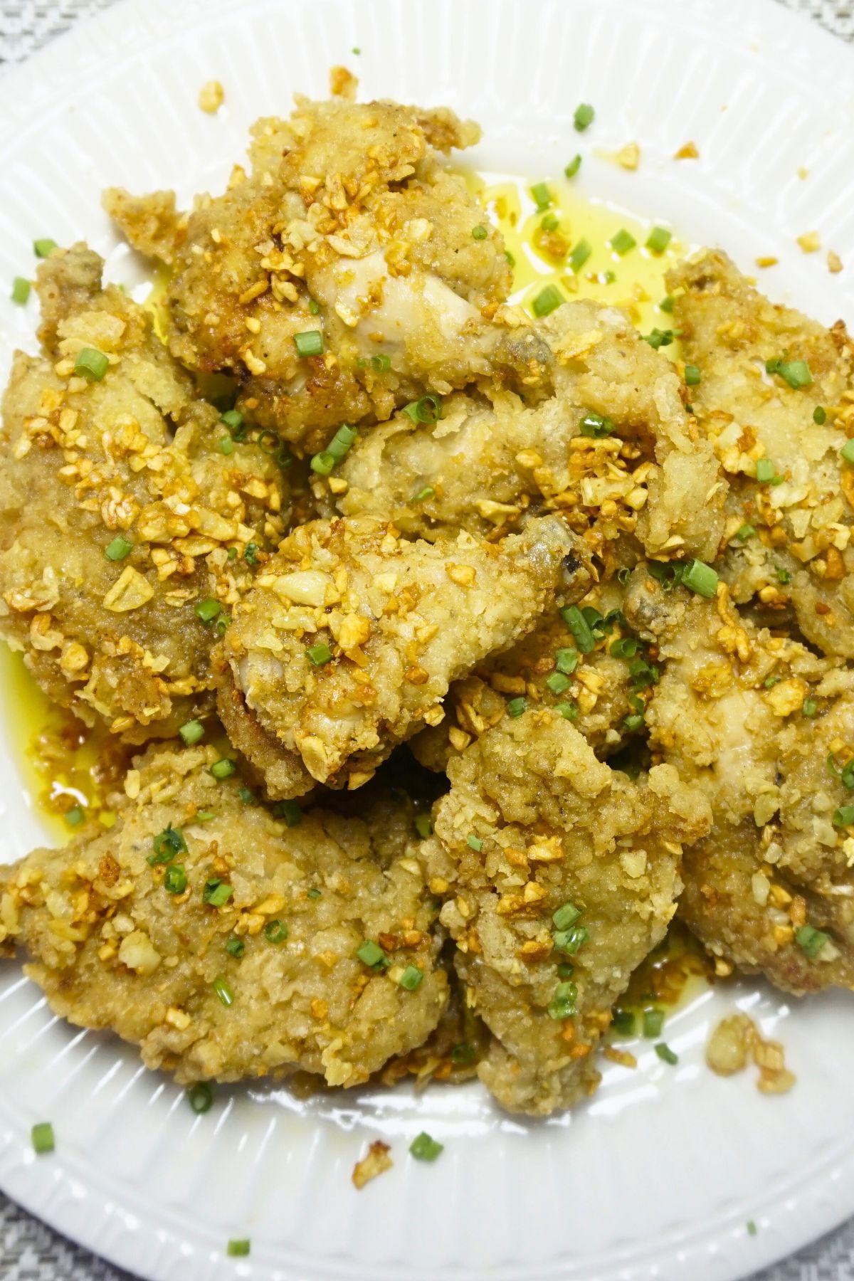 Fried chicken coated in butter and fried garlic.