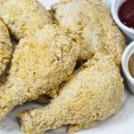 Crispy fried chickens with dipping sauce on the side.
