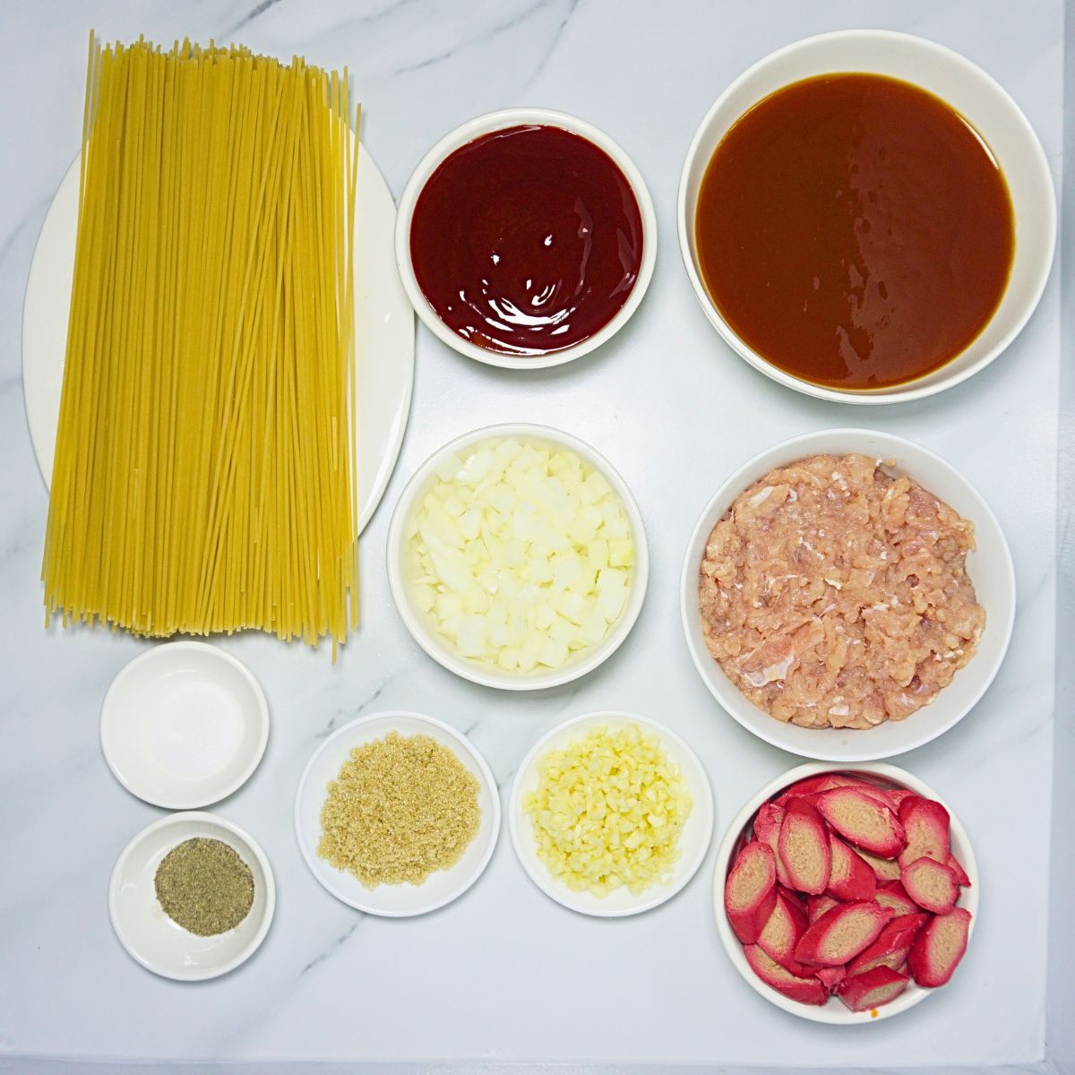 Filipino style spaghetti ingredients. Pasta, ketchup, spaghetti sauce, brown sugar , ground pork, hotdog, onion, garlic, salt and pepper.