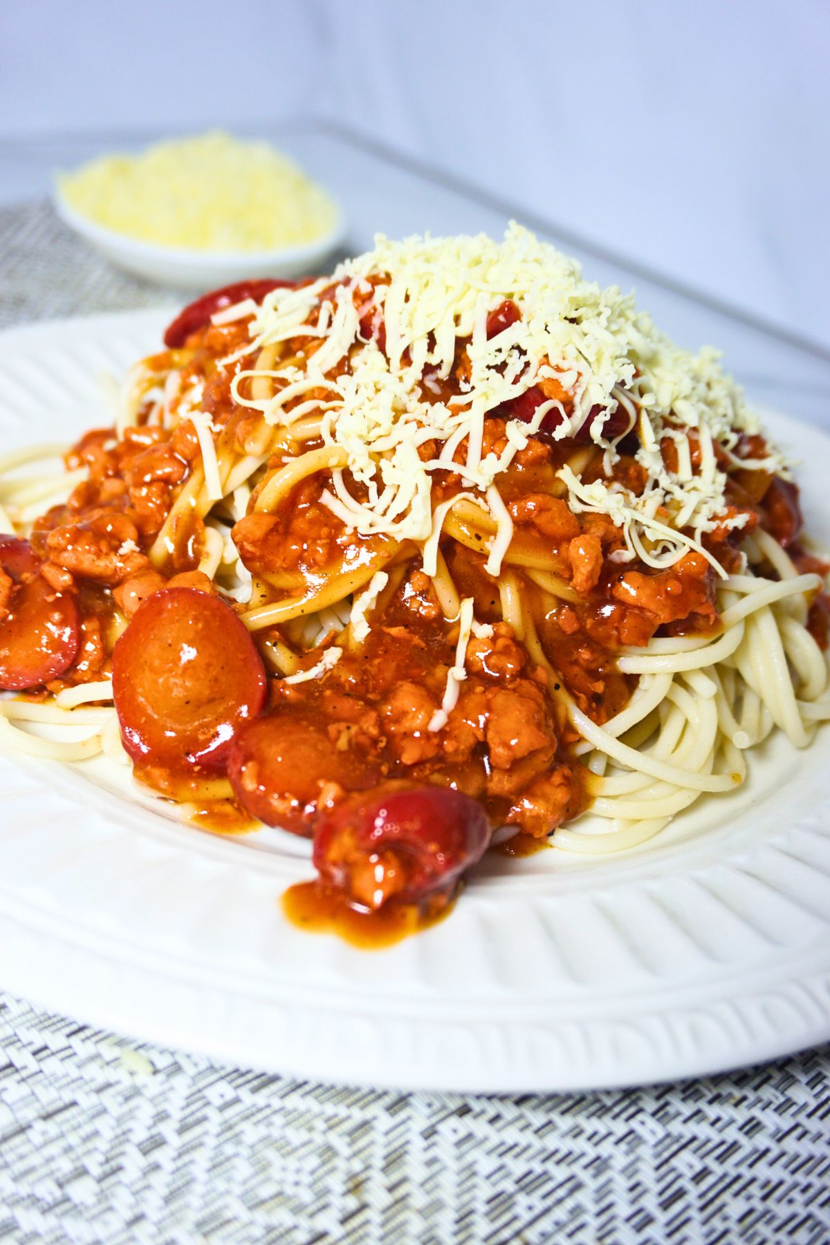 Sweet style spaghetti in a plate with cheese.