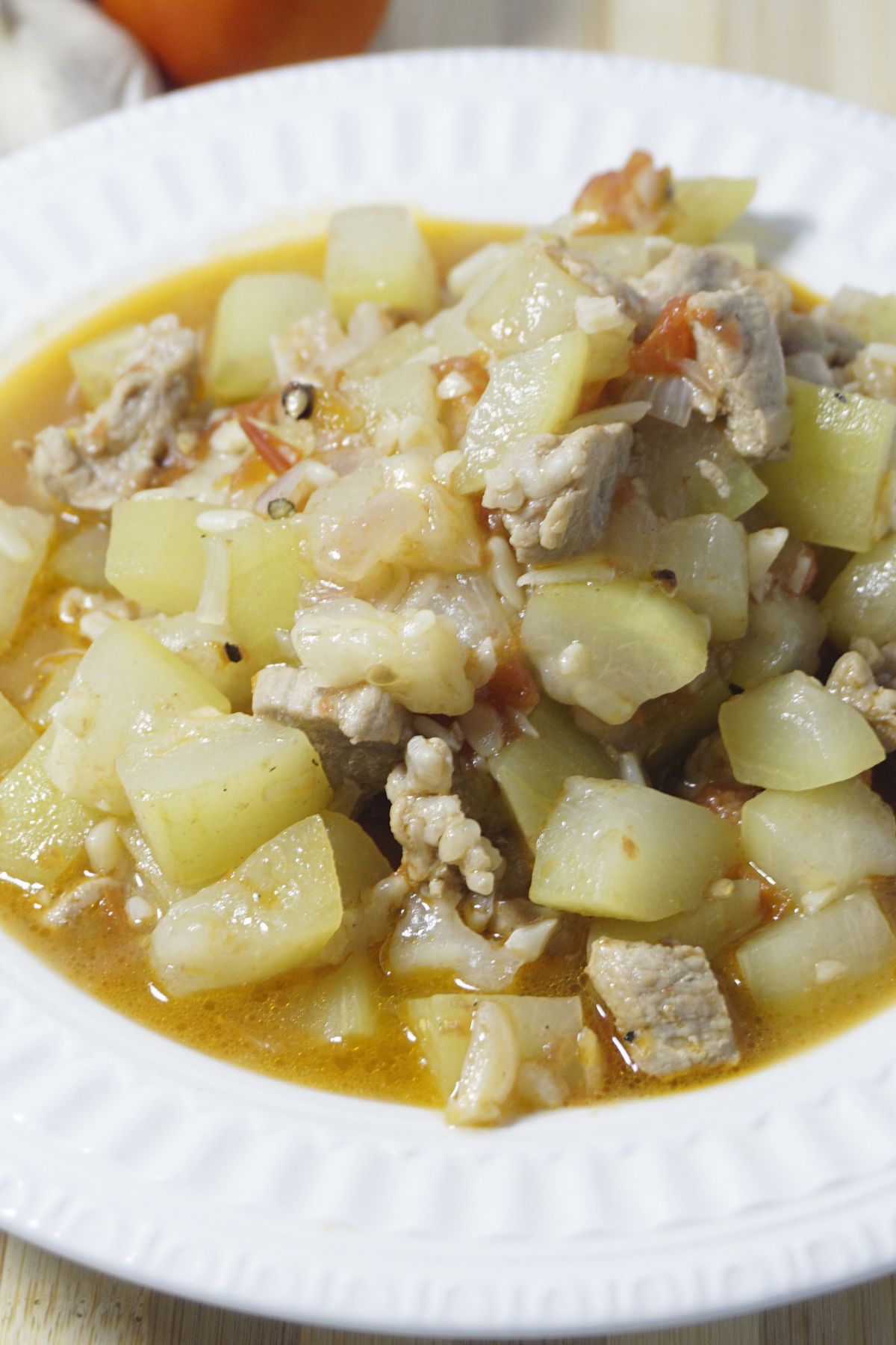 Ginisang upo serving in a white dish.