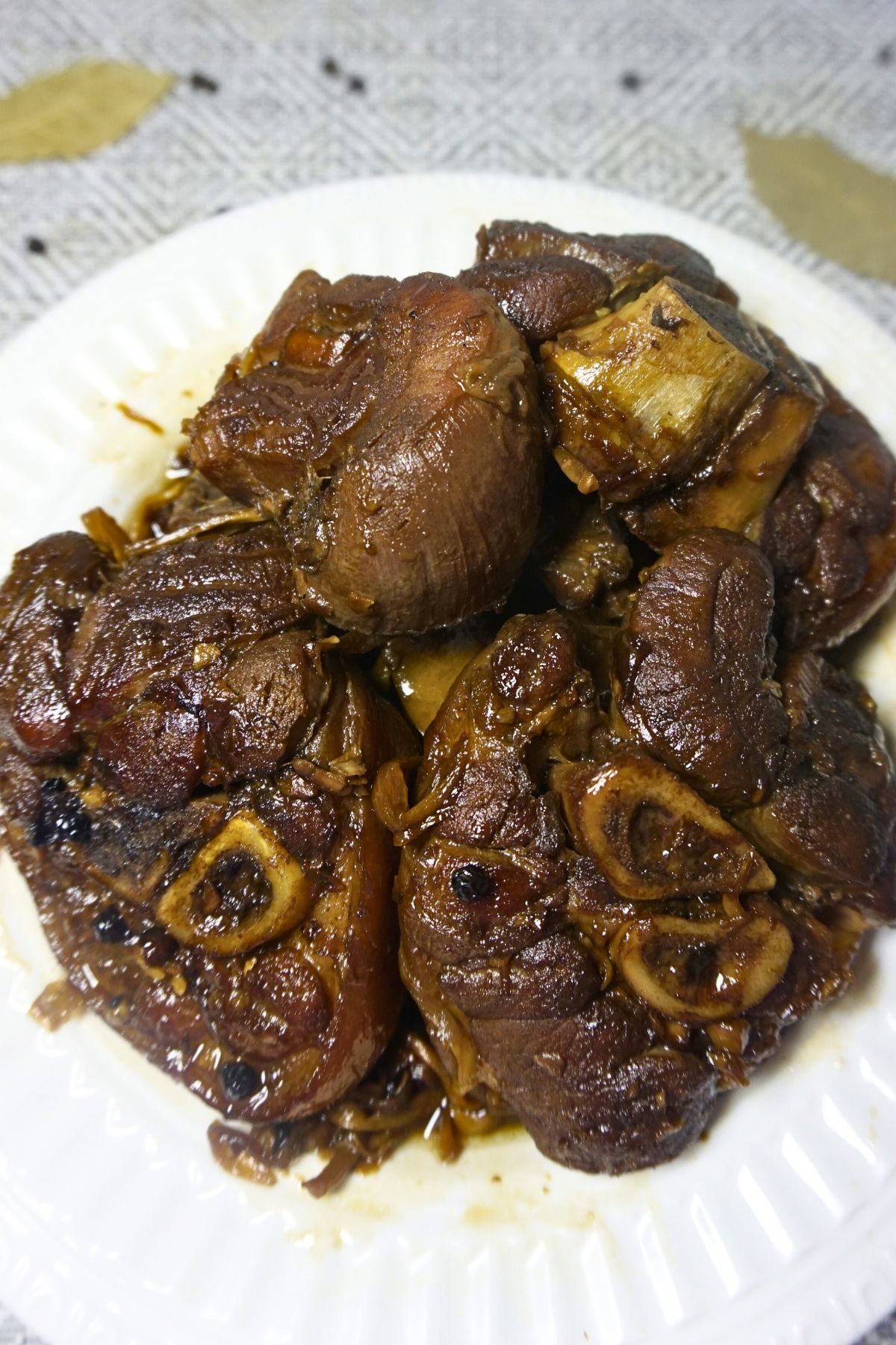 Sauteed pork leg in soy sauce, vinegar, sugar, peppercorns, dry bay leaves, banana blossoms and optional mang tomas sarsa.