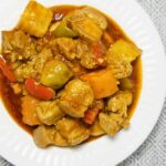 Pork with carrots, potatoes and bell peppers stewed in tomato sauce.