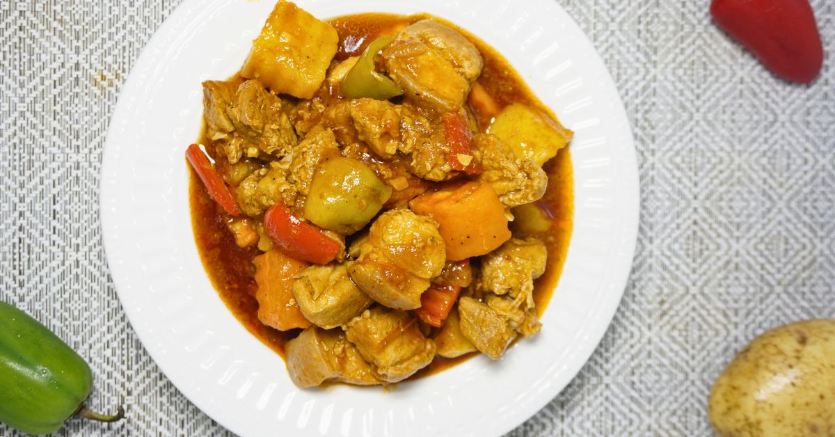 Pork with carrots, potatoes and bell peppers stewed in tomato sauce.