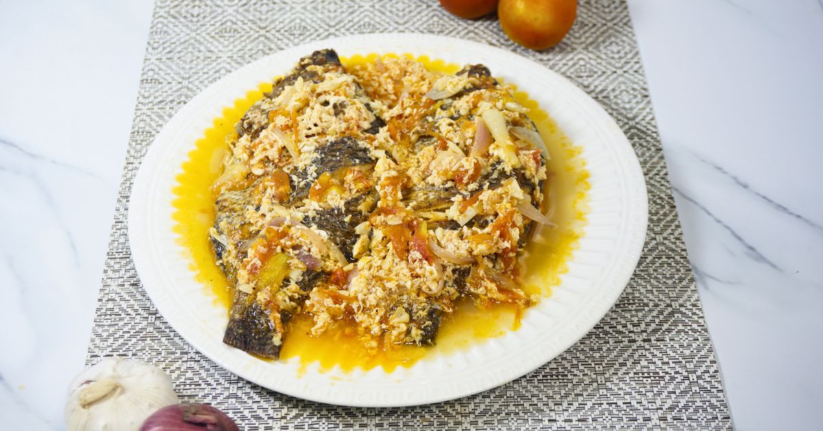 Fried tilapia in tomato sauce with egg.