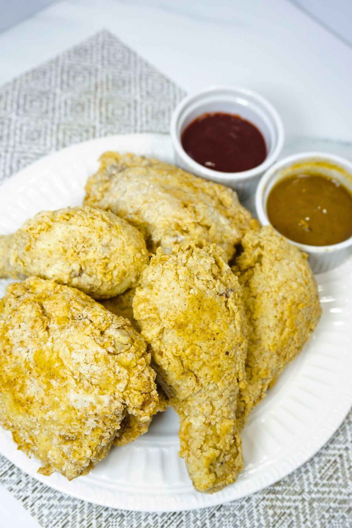 Golden and crispy fried chicken served in a white plate