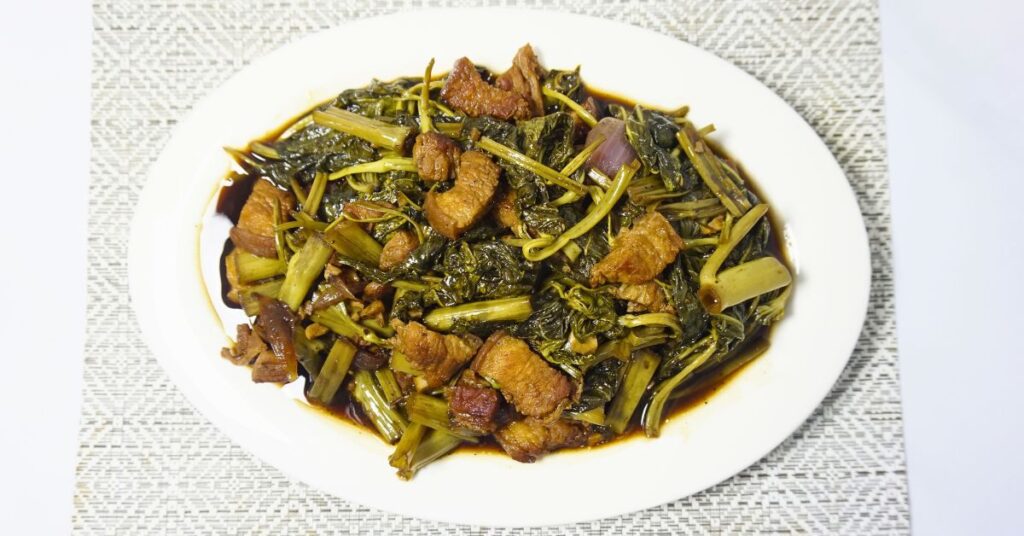 Adobong Kangkong in an oval plate.
