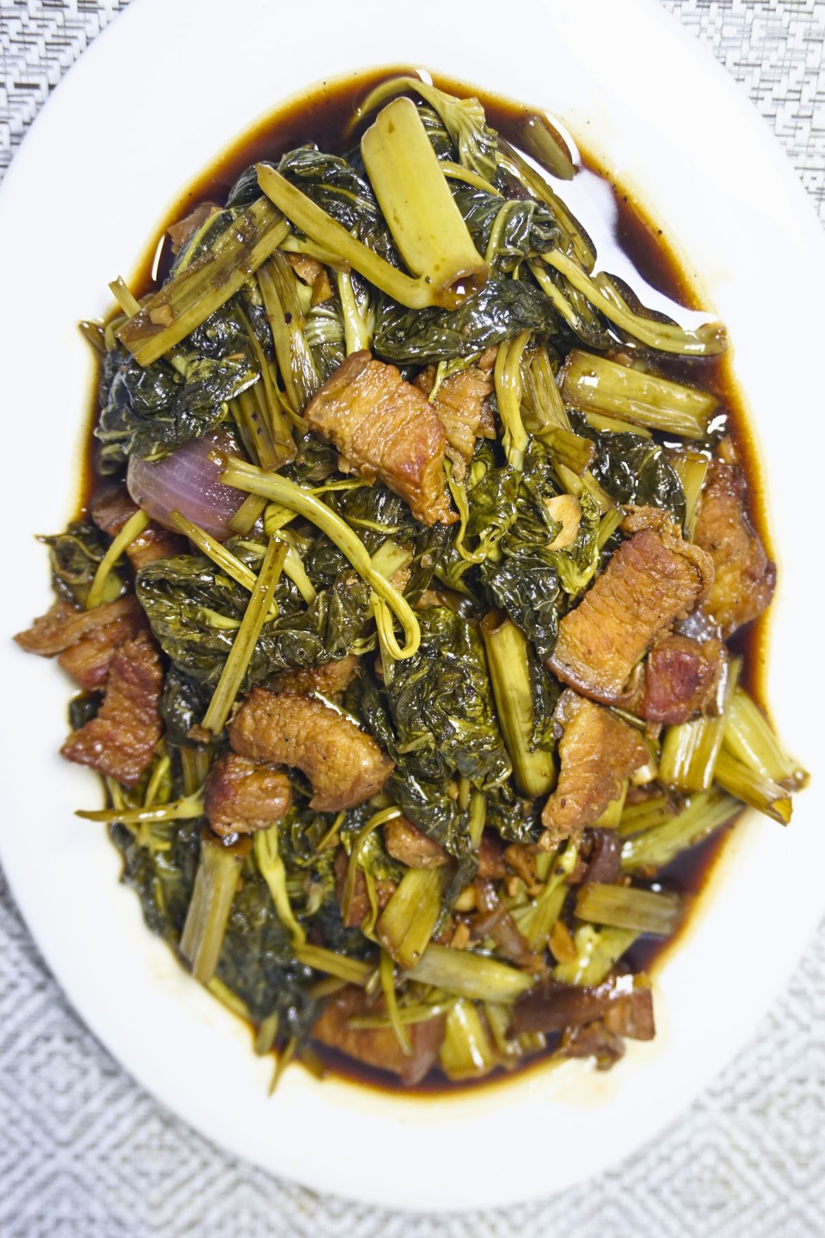 Adobong kangkong with thin slices of pork belly.