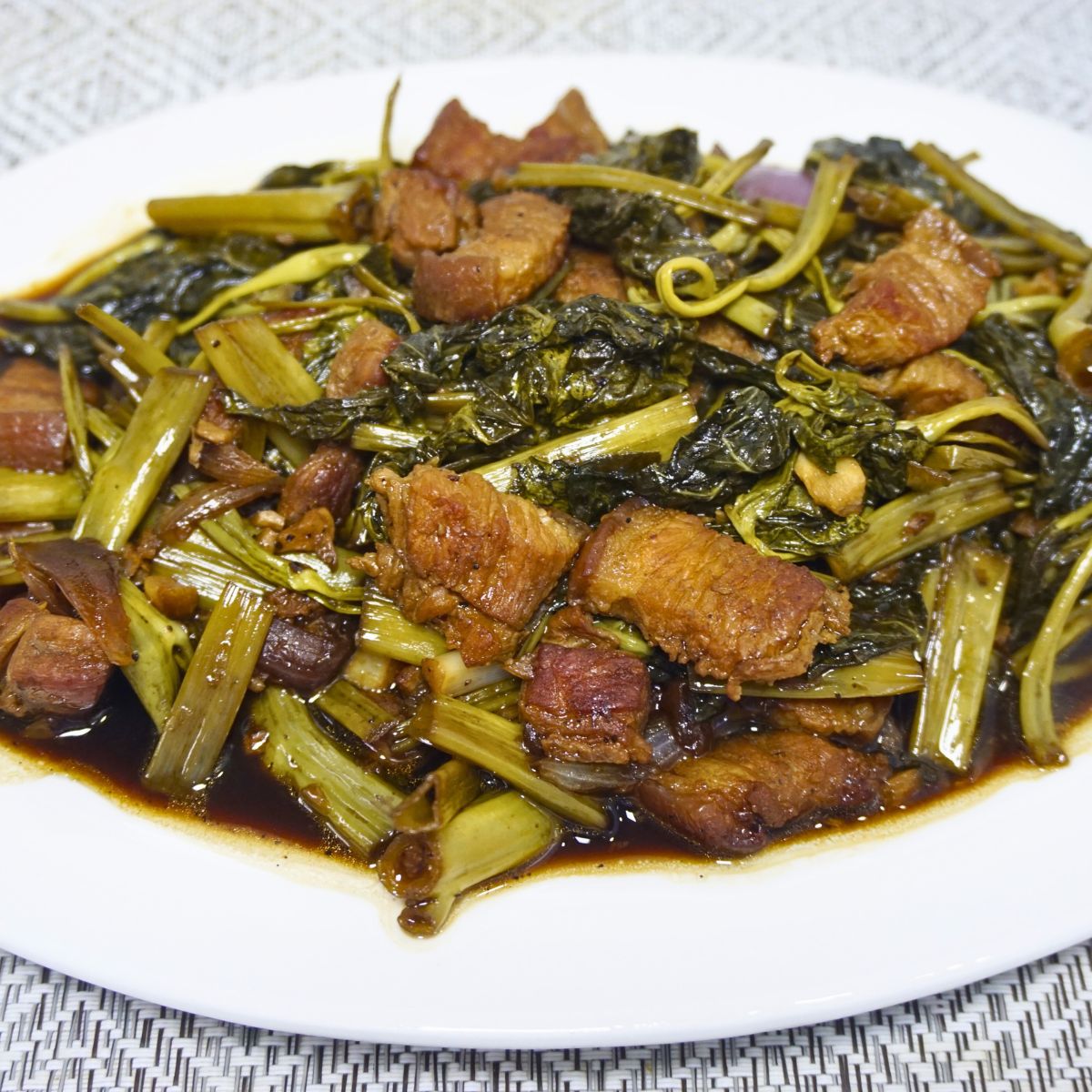 Kangkong leaves and stems sauteed in soy sauce, oyster sauce and vinegar with thin slices of pork belly.