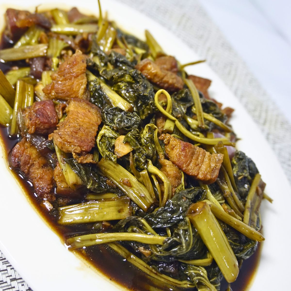 Stir fried pork belly, kangkong leaves and stems in soy sauce and vinegar.