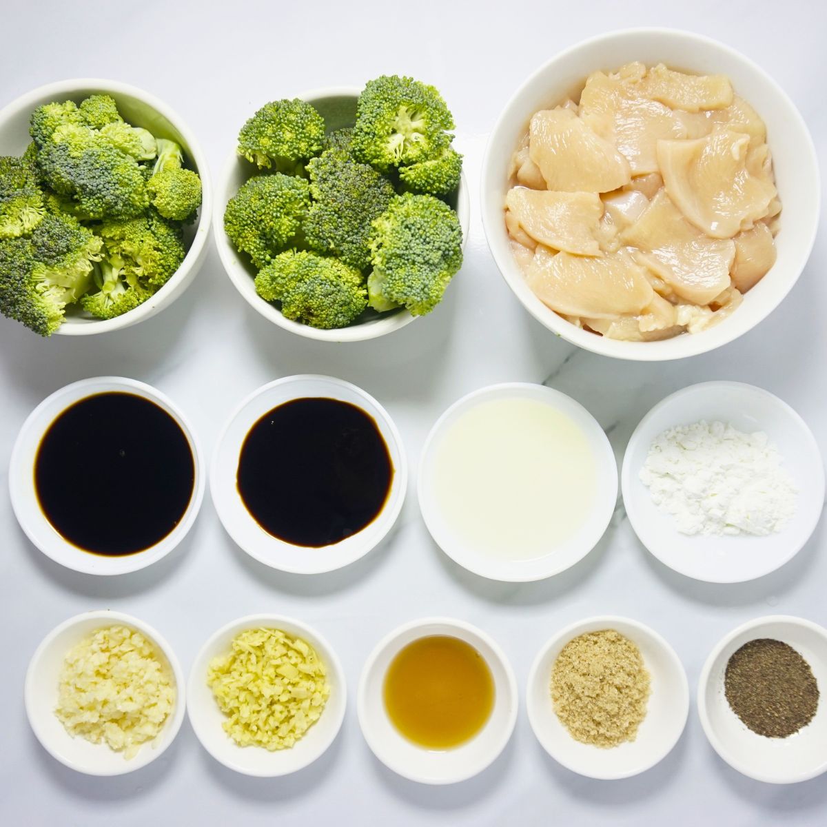Chicken broccoli ingredients. Chicken breast, broccoli, oyster sauce, soy sauce, cooking oil, cornstarch, garlic, ginger, sesame oil, brown sugar and black pepper powder.