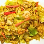 Pancit canton served in a white plate.