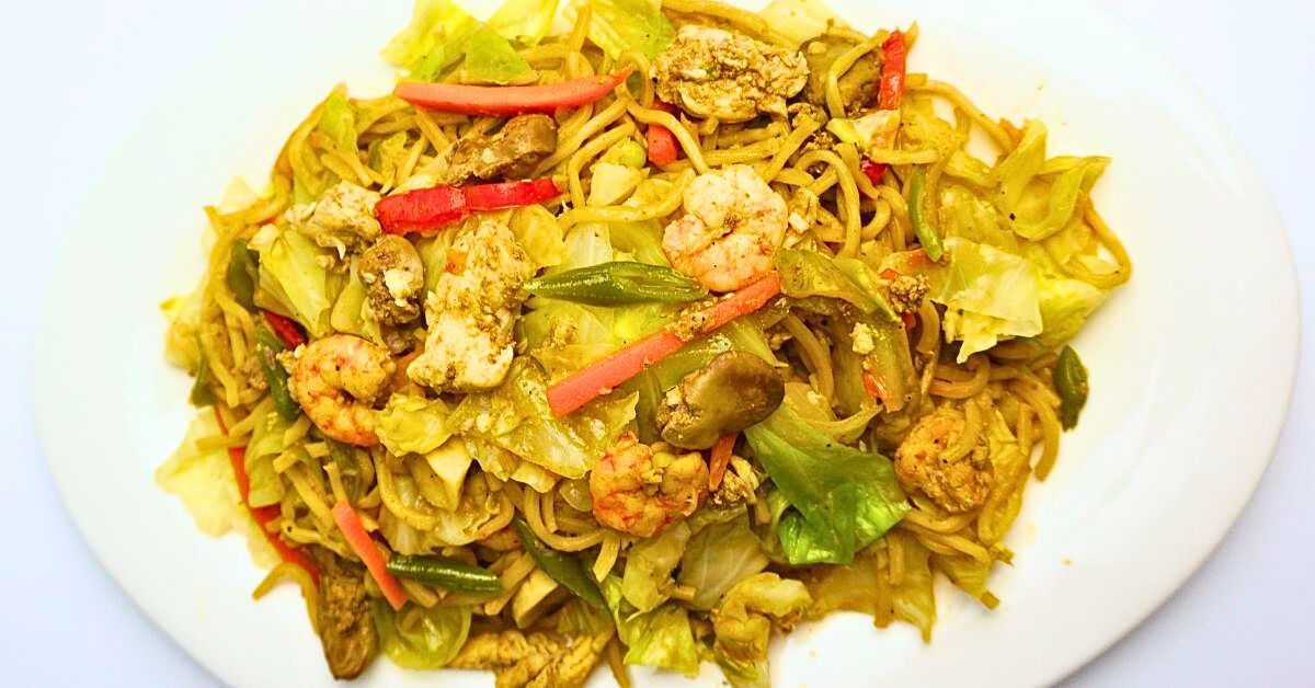 Pancit canton served in a white plate.