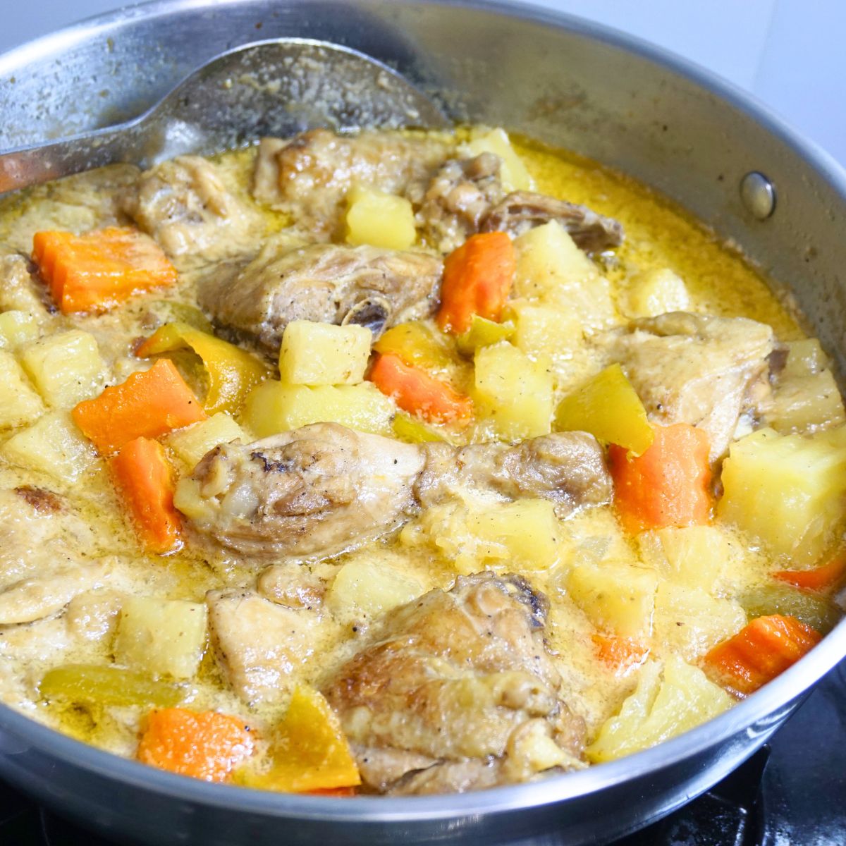 Pininhayang manok cooked in a stainless steel pan.