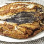 Fried daing na bangus in a plate.