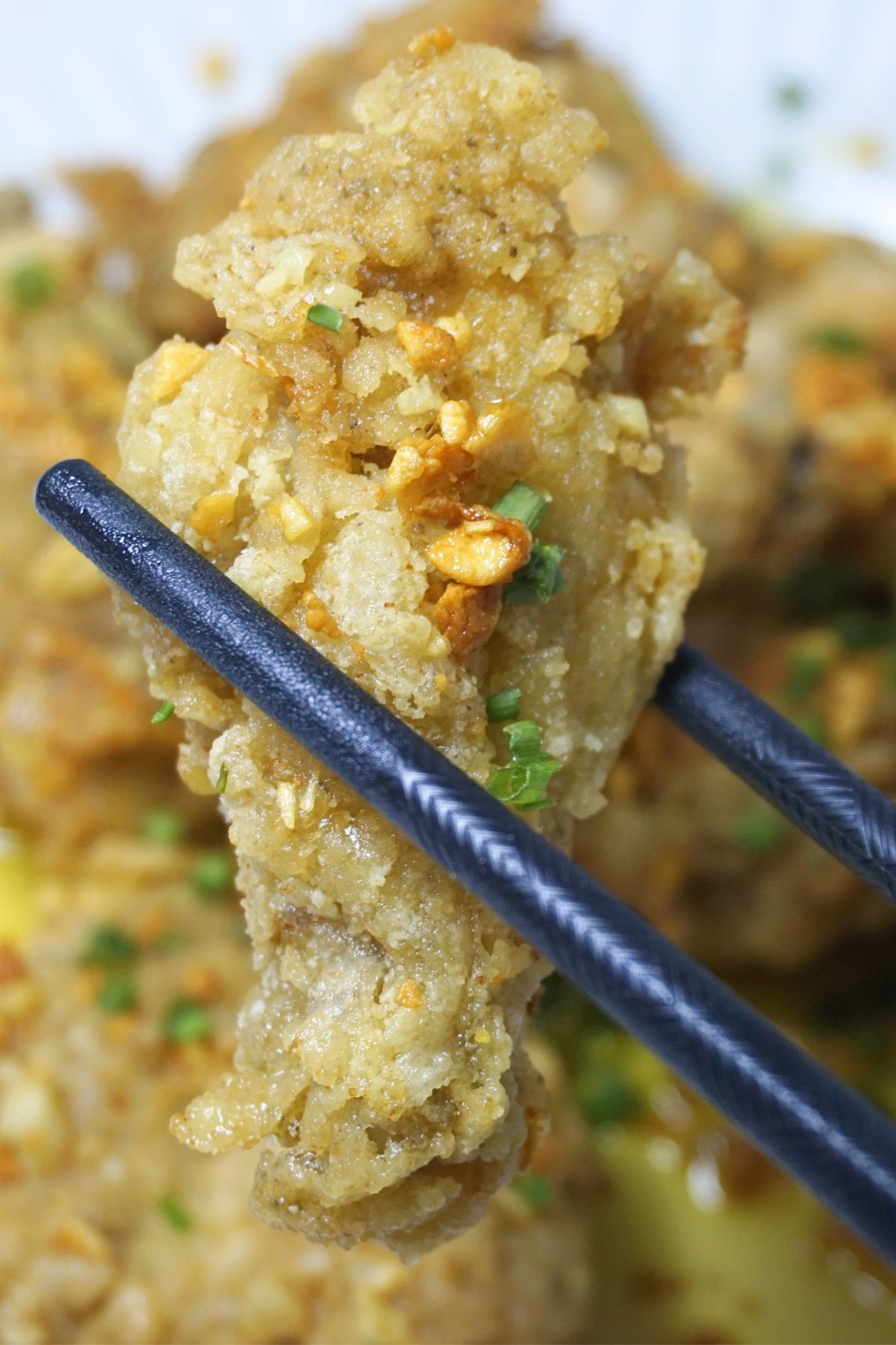 Garlic buttered chicken in chopsticks