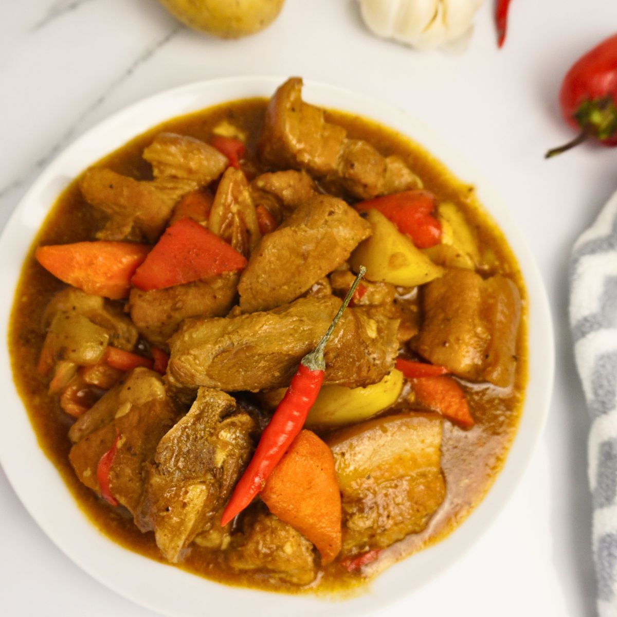 Pork Caldereta with red chili on top