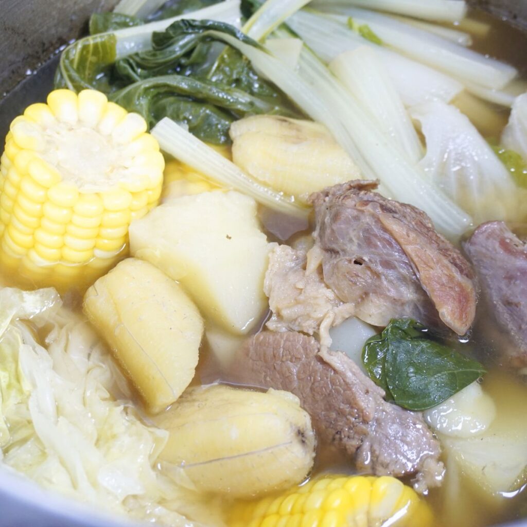 Boiled beef in a large pot.