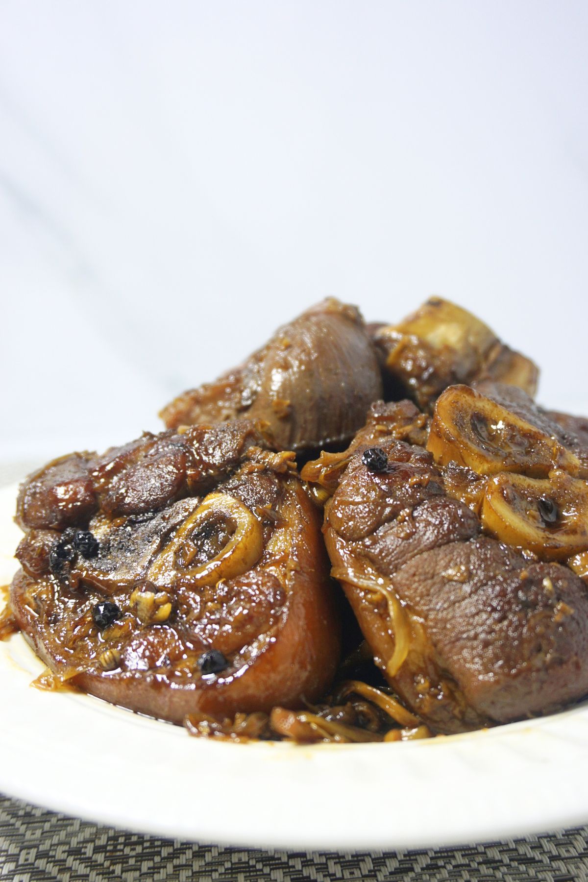 Savory paksiw na para served in a white plate