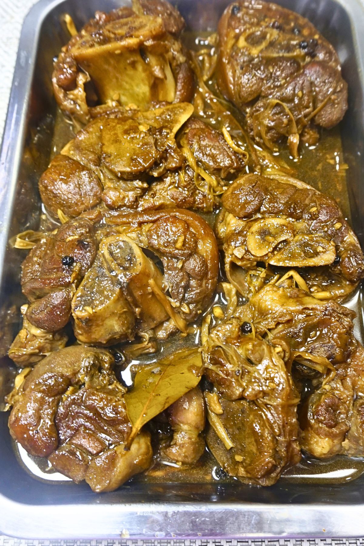 Paksiw na pata served in a steel dish.