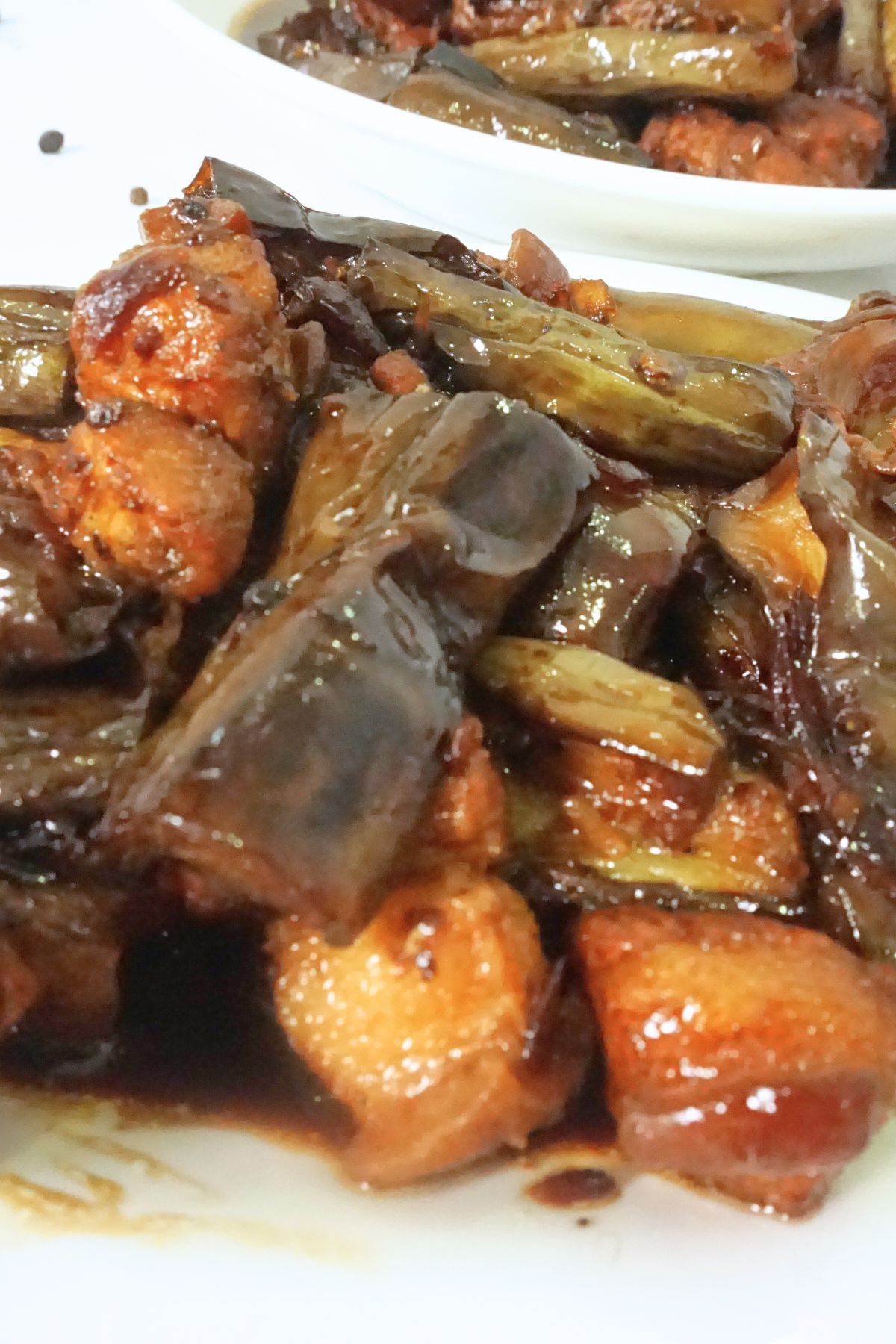 Adobong talong with slices of pork belly
