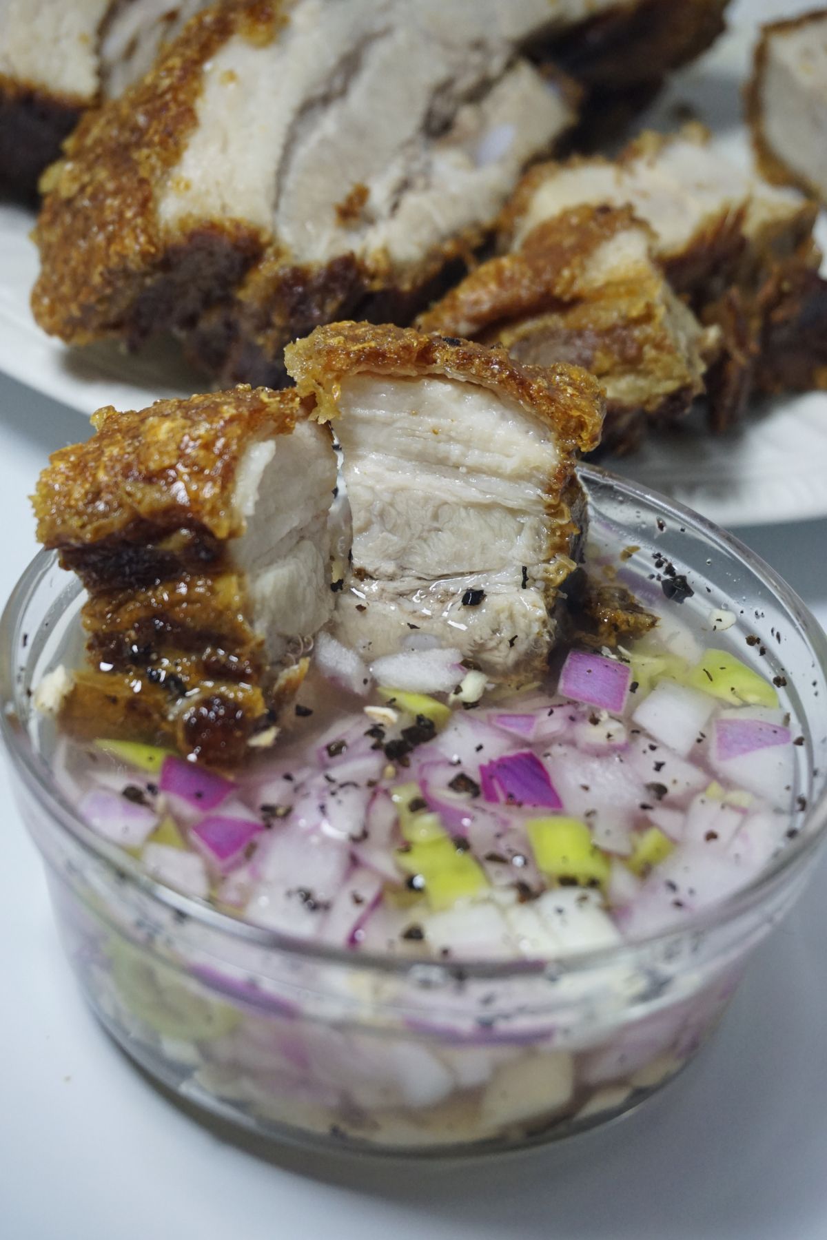 Crispy lechon kawali slice in a vinegar dip